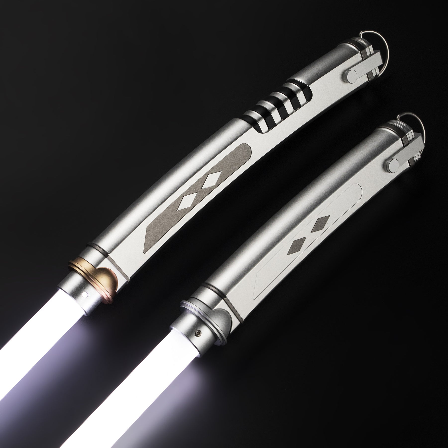 Two Ahsoka Tano replica lightsaber hilts of different lengths side by side, both lit with white blades